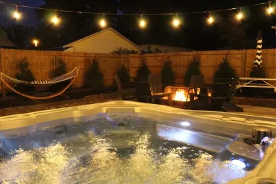 Picture your evenings in the magical backyard. With glowing edison lights, a year-round hot tub, perfect picnic space, ample seating, fire pit, gas grill, and relaxing hammock, it is sure to be a place you'll want to gather. 