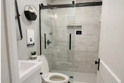 The main level bathroom is located in the heart of the home, between the main floor bedroom and living room. Wash the sand away in the spacious walk-in shower.  