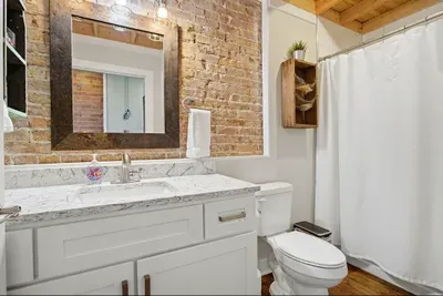 In the bathroom, you'll find a vanity with plenty of cupboard and drawer space, a shower/tub combo, a sink, and a toilet. Fresh white towels, washcloths, hand towels, and makeup towels are all provided for your convenience.