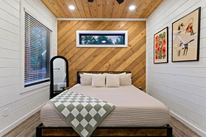 [Downstairs primary] Professionally designed and meticulously decorated. Can you imagine staying in this cozy room?! Hotel grade linens, King bed, and amazing artwork