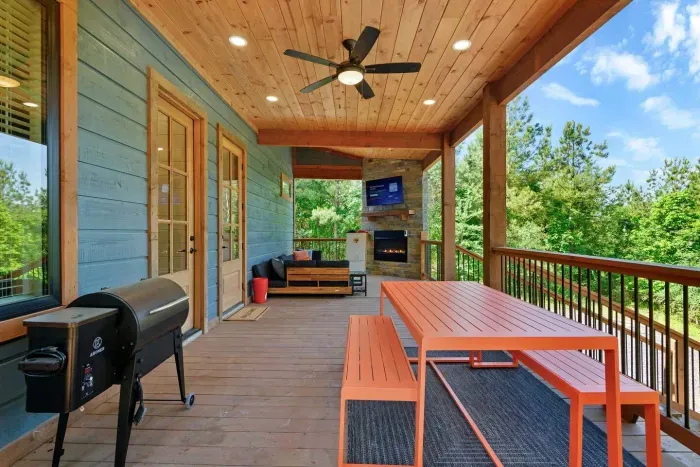 [deck] long view of our huge deck space as you walk back to the main house from the detached hot tub