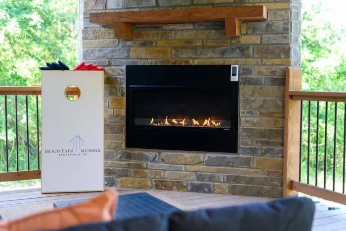 [Backyard Patio] custom corn hole and outdoor fireplace