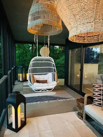 A two person swing to reconnect with nature on the wrap around deck