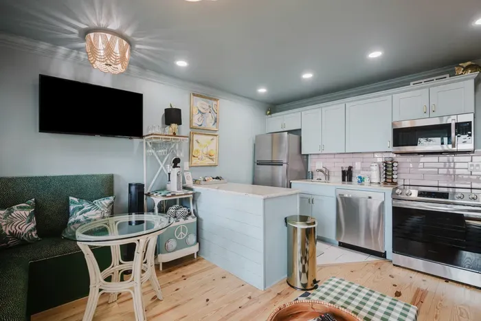 Bright coastal kitchen with island, cozy dining nook, and modern appliances
