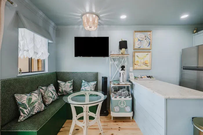 Cozy tropical breakfast nook with TV, kitchenette, and built-in seating