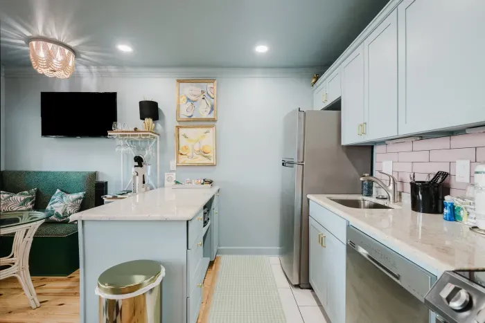 Bright, stylish kitchenette with island seating and cozy lounge nook
