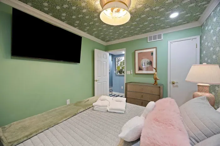 Cozy sleeping space with a queen bed and smart TV