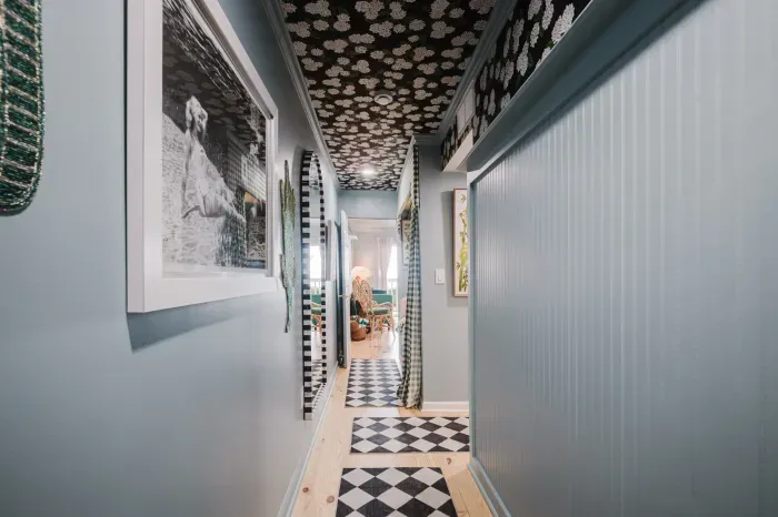 Bold designer hallway with floral ceiling and chic patterned runners