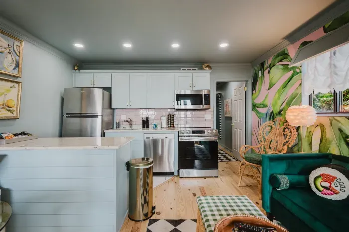 Bright designer kitchen with tropical mural and chic lounge seating