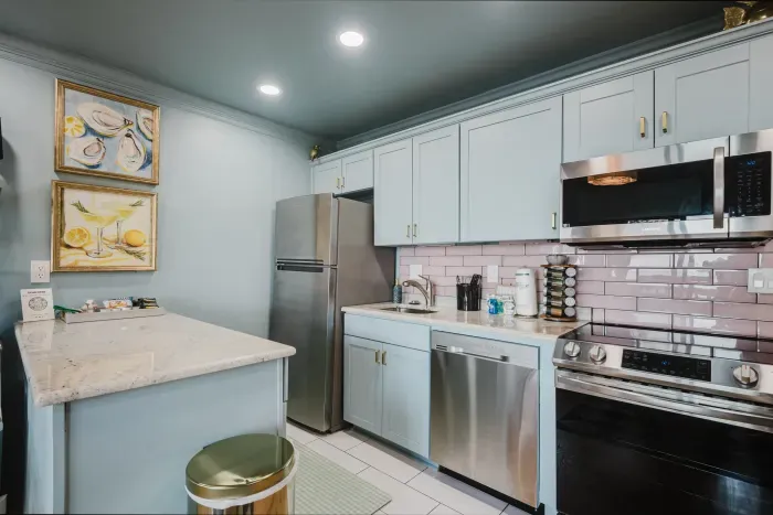 Bright modern kitchen with stainless steel appliances and stylish finishes