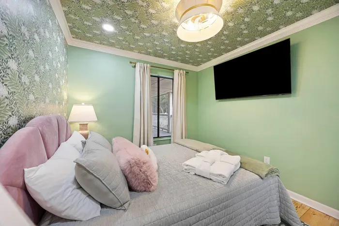 Rest easy in a quiet bedroom with queen bed and smart TV