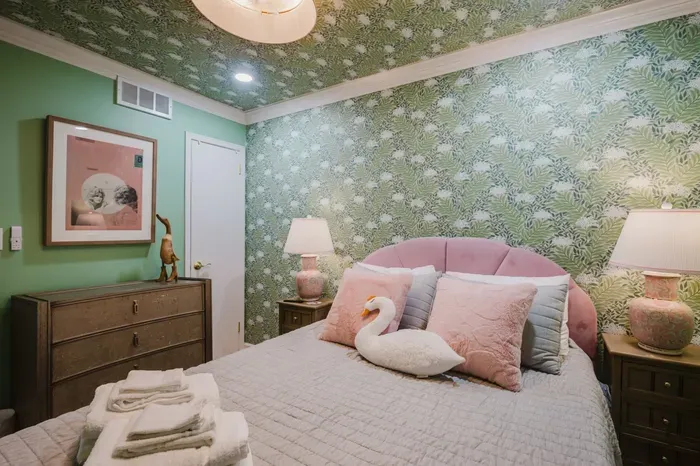Chic botanical bedroom with blush accents and warm bedside lighting