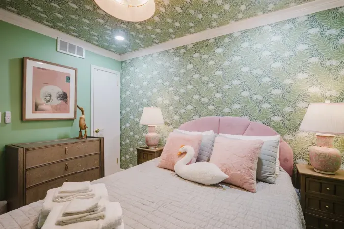 Charming tropical bedroom with pink accents and a cozy, guest-ready feel