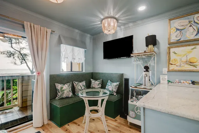 Cozy coastal breakfast nook with built-in seating, TV, and coffee bar