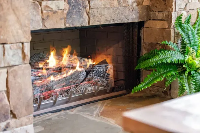 Outdoor stone fireplace on the covered deck for cooler evenings.