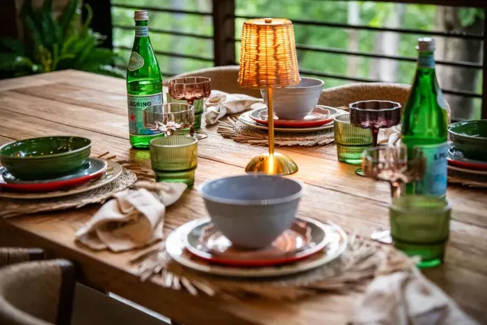 Savor dining al fresco by the outdoor fireplace, where a beautifully set table and the glow of candlelight create the perfect backdrop for unforgettable meals.