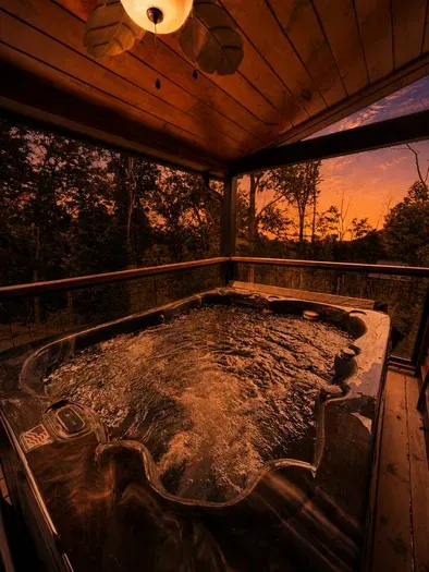 Soak under the stars in your private hot tub, surrounded by peaceful wooded views and the warm glow of sunset. Whether you're unwinding after a day of adventure or enjoying a quiet evening retreat, this is the perfect spot to relax and recharge.