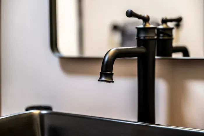 Matte black fixtures and a clean framed mirror. The bathrooms got the same attention as everything else.