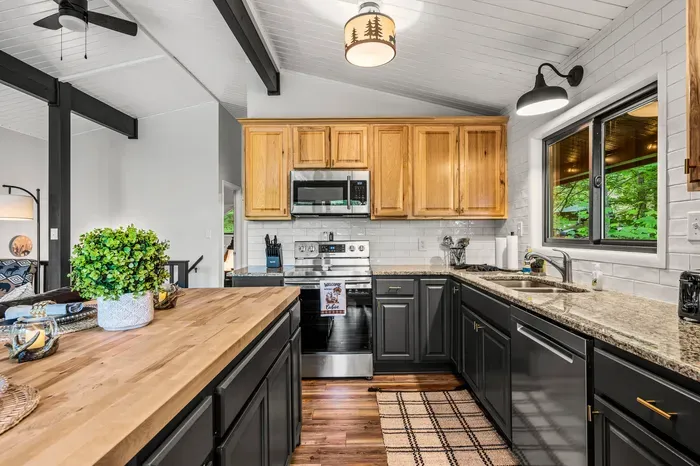 Full-size range, microwave, dishwasher, and counter space to actually use them. Knife block and utensils already stocked.