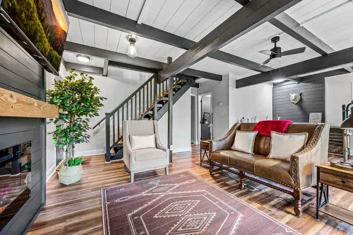 Open floor plan front to back — living, wet bar, and stairs all flow together, so nobody's stuck in a separate room.