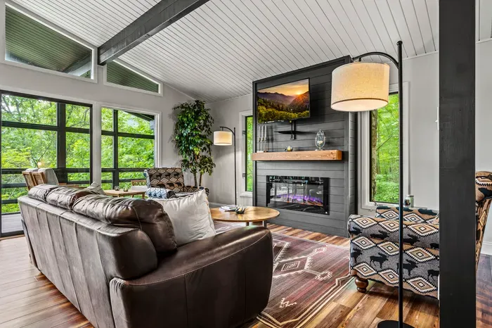 Screened porch just past the glass with more seating out there. Open the door and the room doubles.