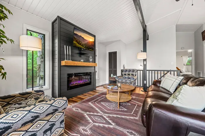 Sofa and two oversized armchairs facing the fire. Room for everyone to actually sit down at the same time.