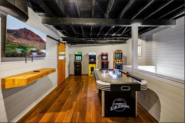 Full game room downstairs: air hockey, four arcade cabinets, and a big-screen TV. Where the kids disappear to for three hours.