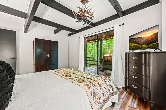 Wardrobe for actually unpacking, TV on the dresser, and the porch six feet from the foot of the bed.
