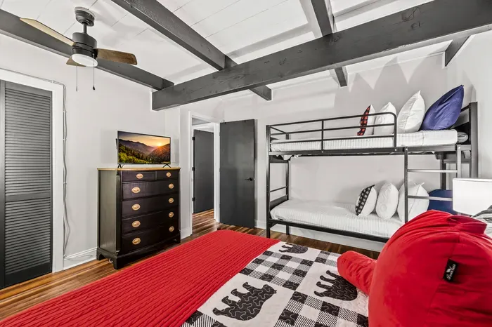 Dresser, smart TV, and closet in the bunk room — the kids get a real bedroom, not an afterthought.