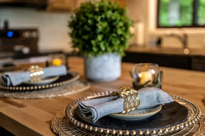 Butcher block island set for dinner in. Real plates, real napkins, room to spread out — because takeout every night was never the plan.