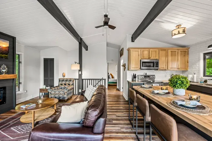 Open front to back — living, island seating, kitchen, and a bedroom just down the hall. One level, everything connected.