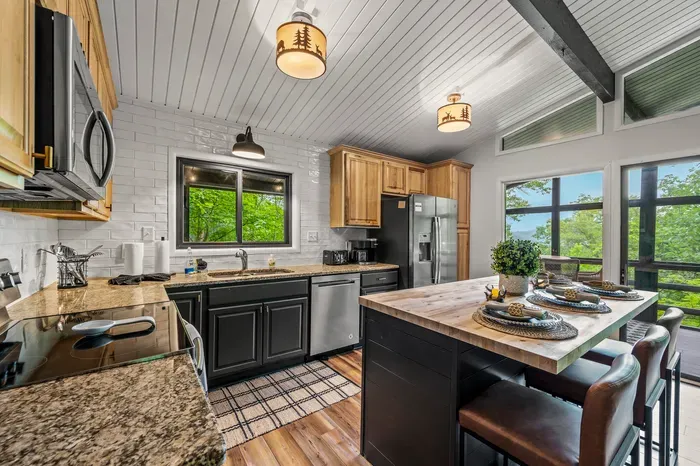 Full kitchen with granite counters, stainless appliances, and a butcher block island seating four. Cook for the whole group without anybody standing in a hallway.