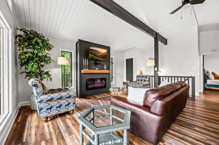 Sofa and two oversized armchairs facing the fire. Room for everyone to actually sit down at the same time.