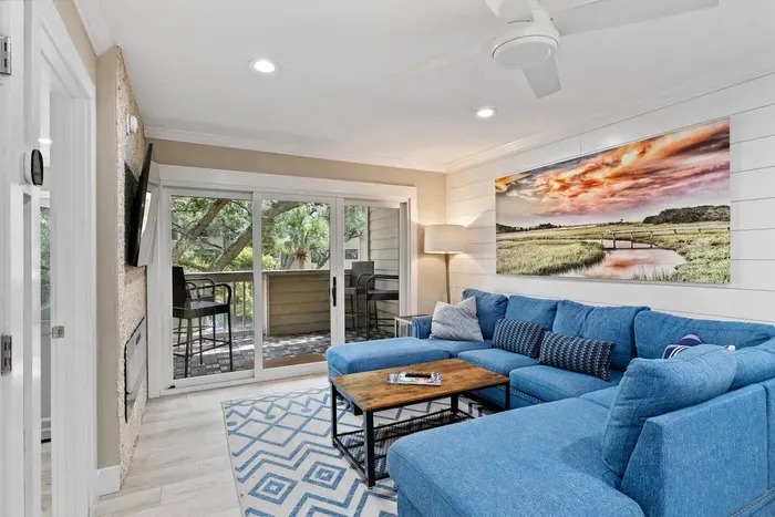 Natural light floods through  glass door, casting a warm glow on carefully curated decor and thoughtfully selected furnishings.