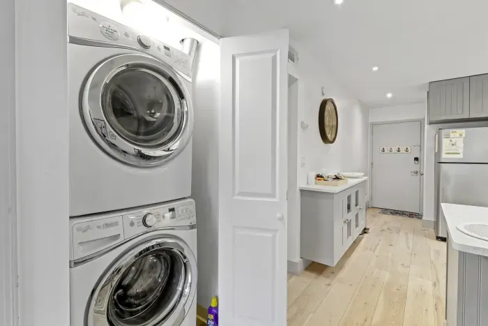 Bright entry hall with in-unit washer/dryer and clean modern finishes