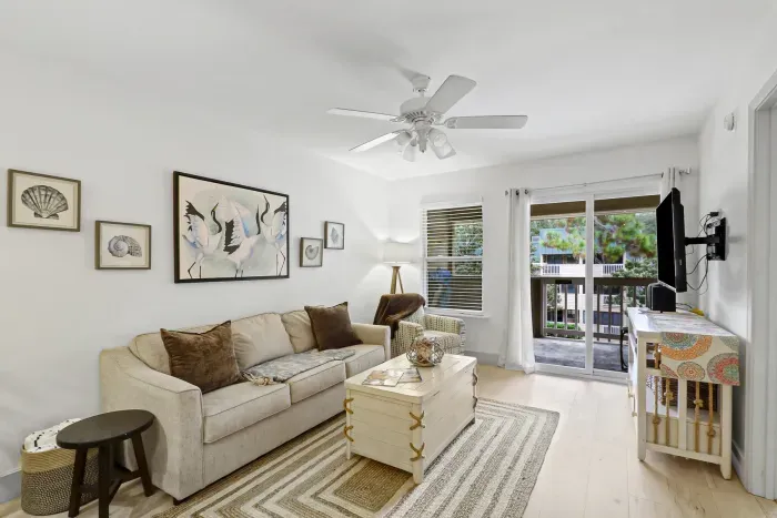 Bright coastal living room with balcony access and relaxing natural light