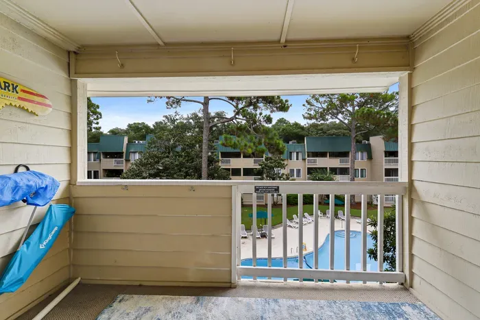 Covered balcony with pool views and a relaxing resort-style setting