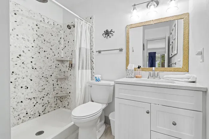 Bright modern bathroom with tiled walk-in shower and stylish vanity