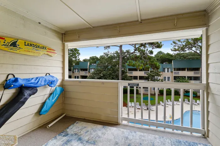 Private covered balcony with pool views and a relaxing resort-style setting