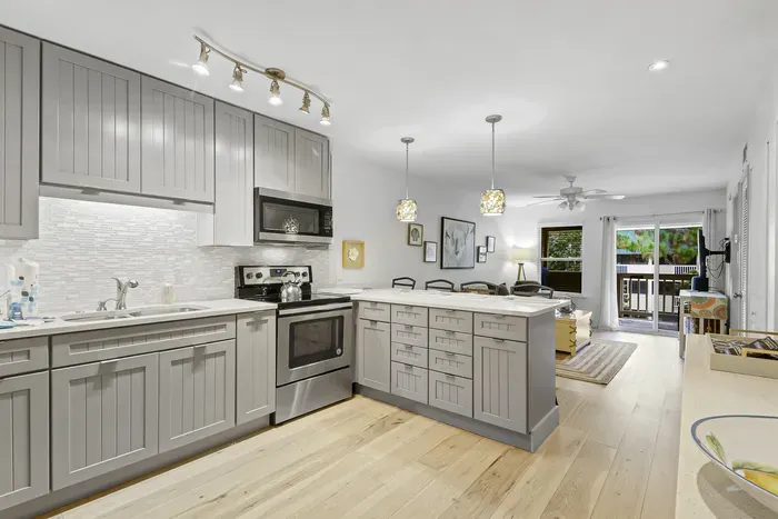 Bright modern kitchen with island seating and private balcony access