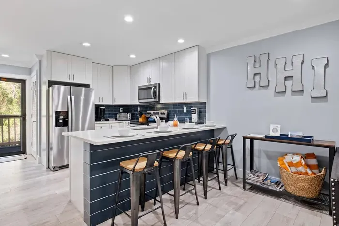 Dining area wit up to date kitchen that is stocked.