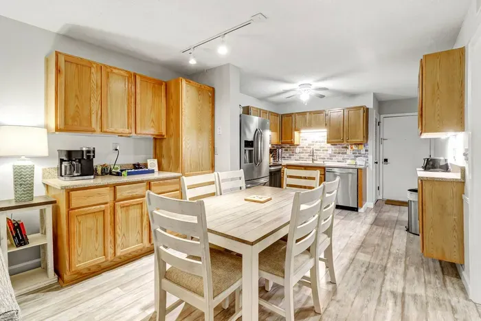 Neutral tones may be complemented by accent colors of the cabinets and dining.