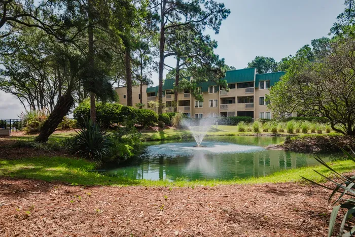 Tranquil pond views with fountain and lush, resort style grounds.