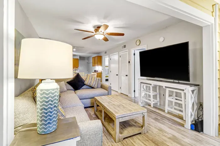 A state-of-the-art Smart TV, seamlessly integrated into the living room's aesthetic. .