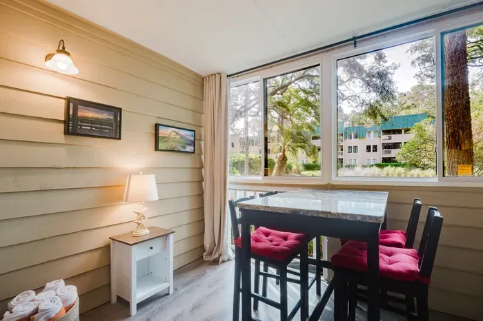 Morning light pours in through three walls of windows. Fresh towels stocked and waiting for the beach.