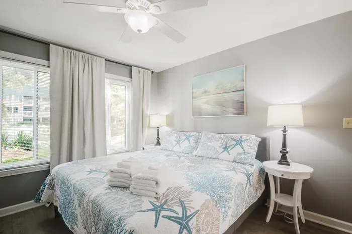 King bed, blackout-lined curtains, and a ceiling fan for the ones who sleep cold. Wake up to green views, not a parking lot.