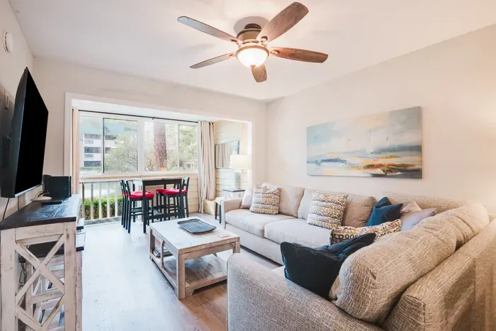 Ceiling fan on, windows open, feet up. The balcony bistro set is where morning coffee and the last drink of the night both happen.