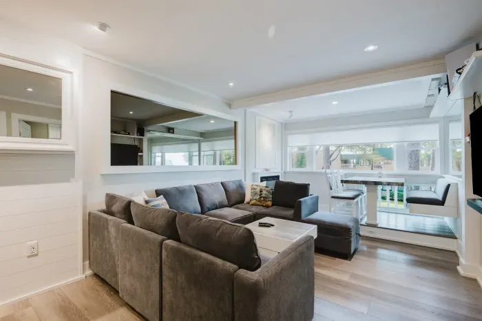 Bright modern lounge with sectional sofa and sunny window-side dining nook