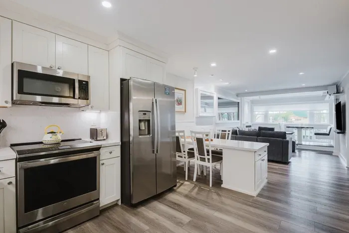 Bright open-concept kitchen, dining, and lounge with modern finishes