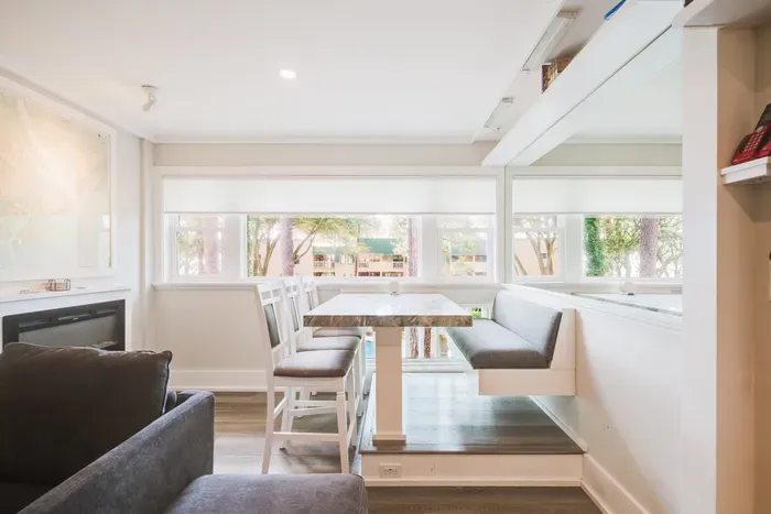 Sunny built-in dining nook with banquette seating and serene window views
